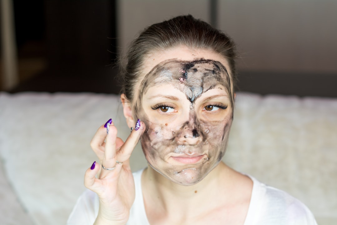 Photo by Bermix Studio a woman with a face mask on holding her hand up to her face